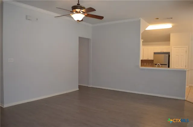 a view of a room with a large window and chandelier