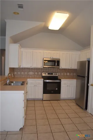 a kitchen with a sink and cabinets