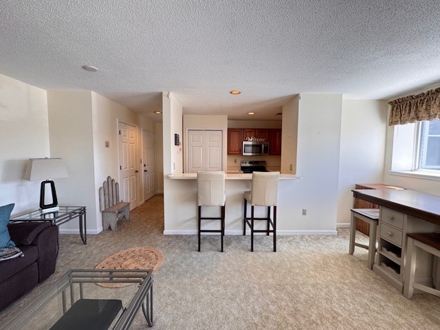 140 High Street, Unit 204 Westerly, RI 02891 - Photo 20 of 20 The open floor plan allows for a dining area beside the kitchen breakfast bar. Shown is a high top style dining set with stools.