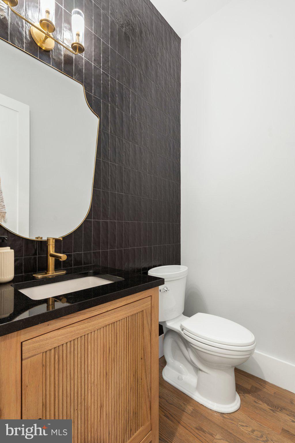 1122 Ormond Court McLean, VA 22101 - Photo 24 of 68 Powder room with wall of black designer tiles
