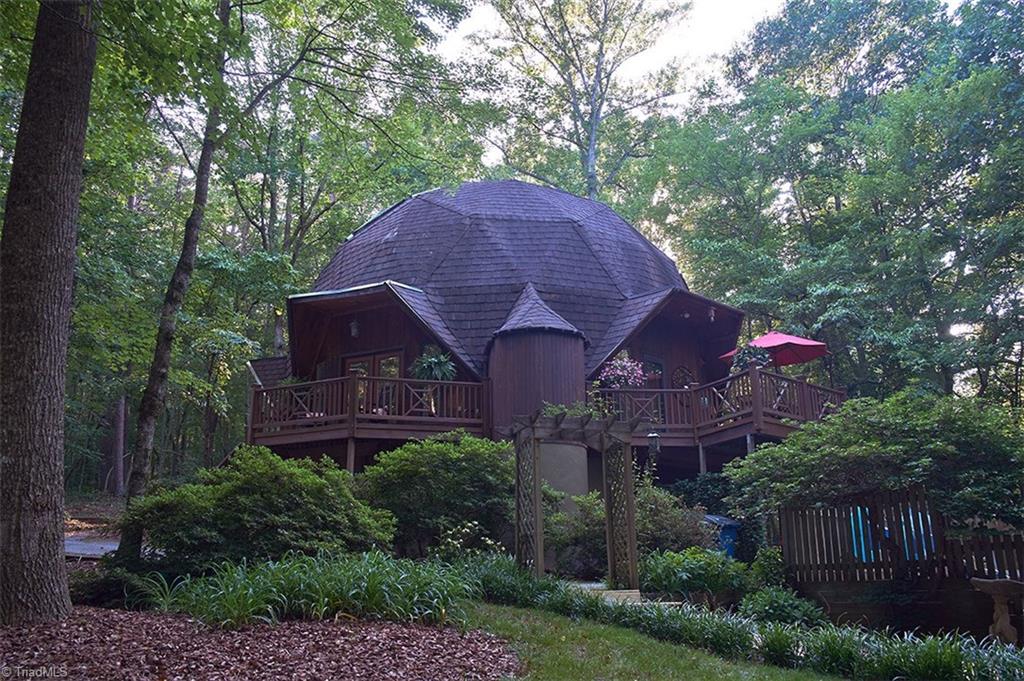 5205 Rambling Road Greensboro, NC 27409 - Photo 1 of 30 Unique Geodesic Dome home with 2 decks on a beautiful 1.46 acre corner wooded lot with 2 separate driveways and parking areas!