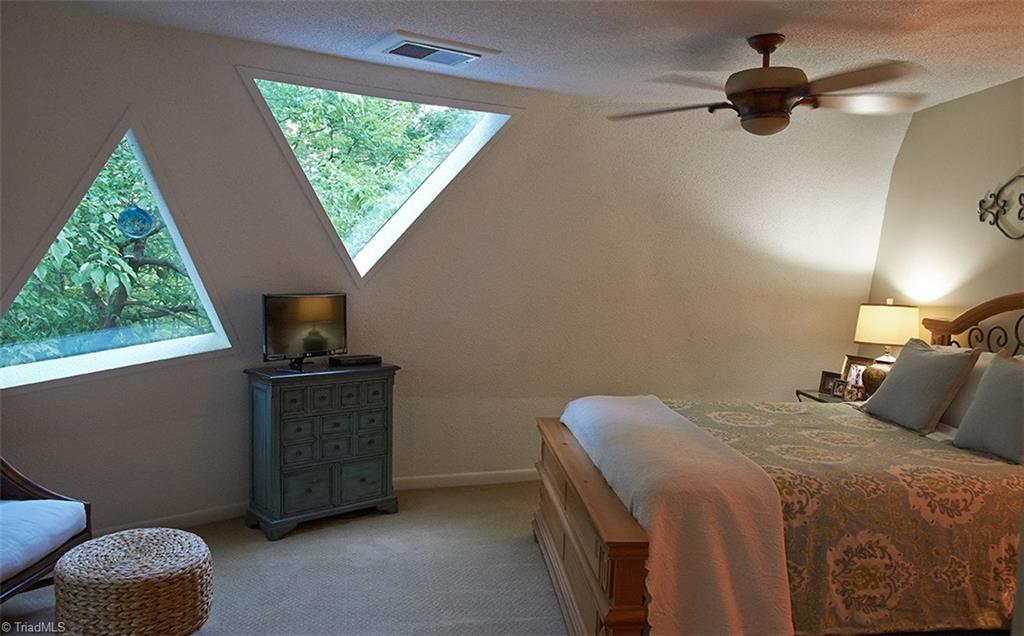5205 Rambling Road Greensboro, NC 27409 - Photo 19 of 30 Peaceful & serene Master bedroom with unique triangle shaped windows!