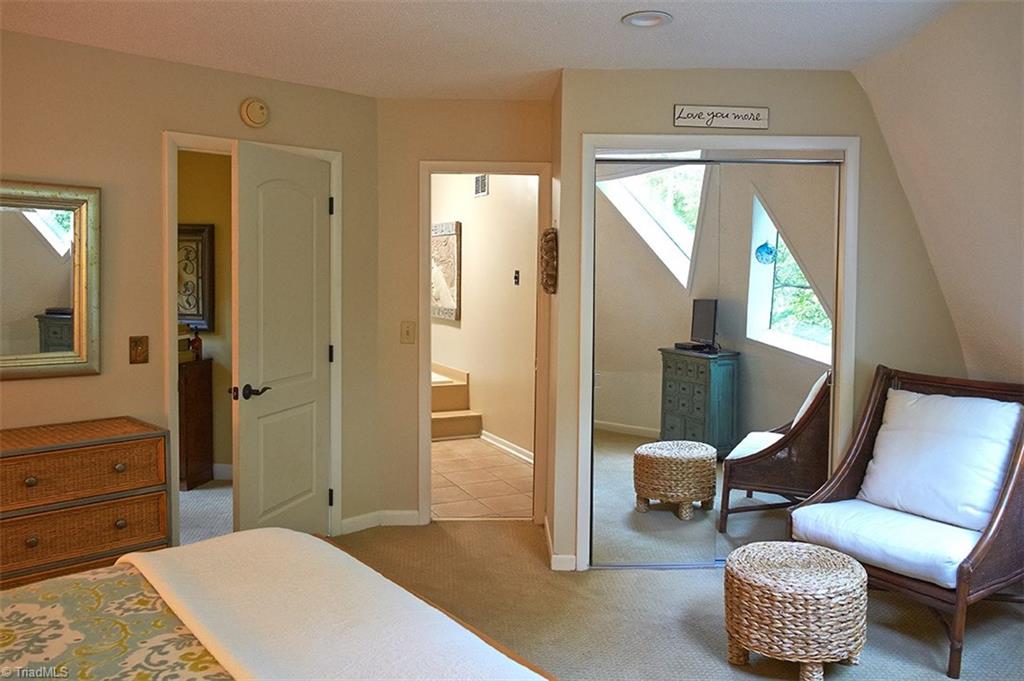5205 Rambling Road Greensboro, NC 27409 - Photo 21 of 30 Entrance to master bedroom on the left, and closet with mirrowed doors on the right. Note the reflection of the unique bedroom windows! Middle door leads into master bath.