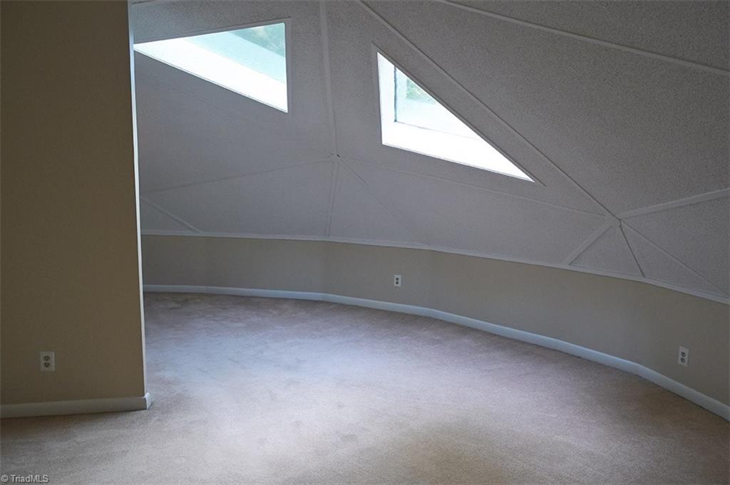 5205 Rambling Road Greensboro, NC 27409 - Photo 24 of 30 Third floor bonus room with domed ceilings & unique triangle shaped windows. This room would be perfect for an office, studio, yoga room, or play room!