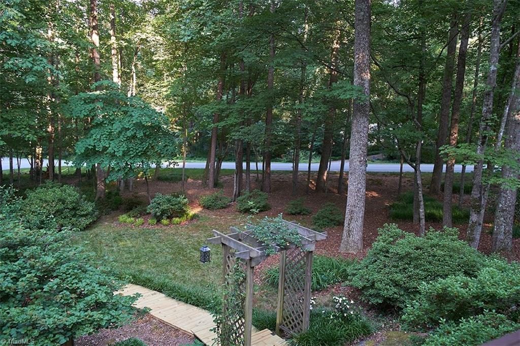 5205 Rambling Road Greensboro, NC 27409 - Photo 29 of 30 View from the deck off the great room. This is the boardwalk leading from the second driveway of this corner lot. With 2 separate driveways, you'll always have plenty of parking for your family & guests!