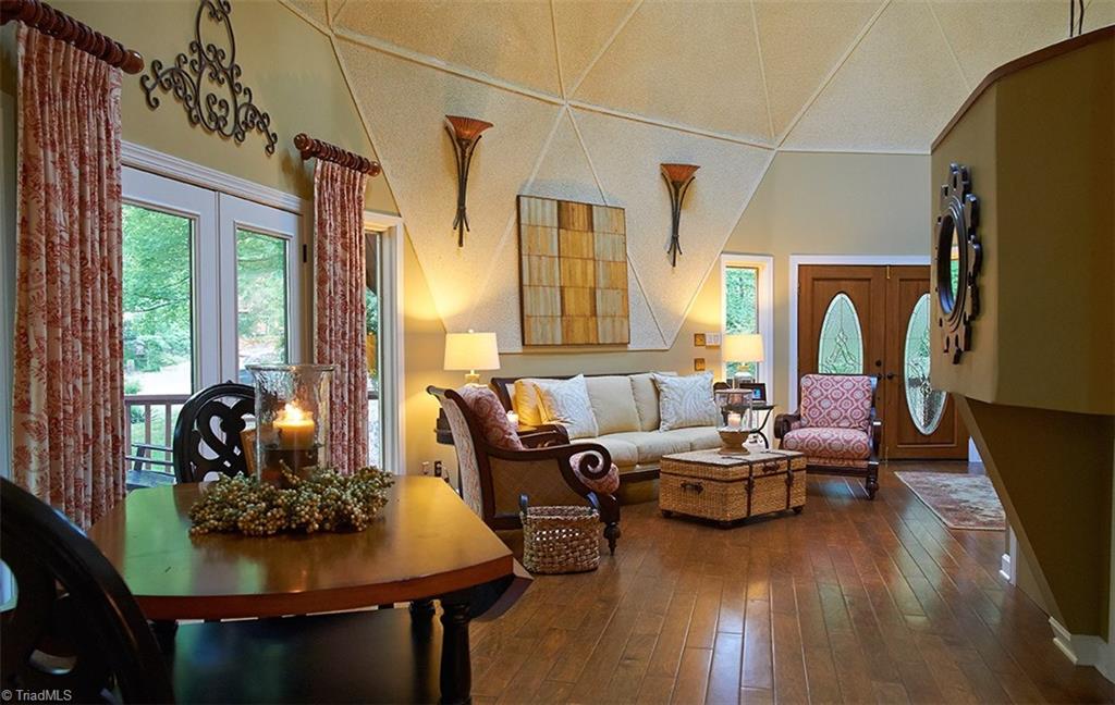 5205 Rambling Road Greensboro, NC 27409 - Photo 6 of 30 Open & spacious great room & dining room. Beautiful engineered wood floors & decorative sconces accentuate the dramatic domed ceilings!