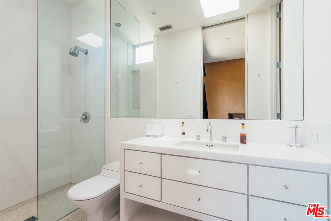 1470 Carla Ridge Beverly Hills, CA 90210 - Photo 22 of 44 a bathroom with a sink a toilet and shower