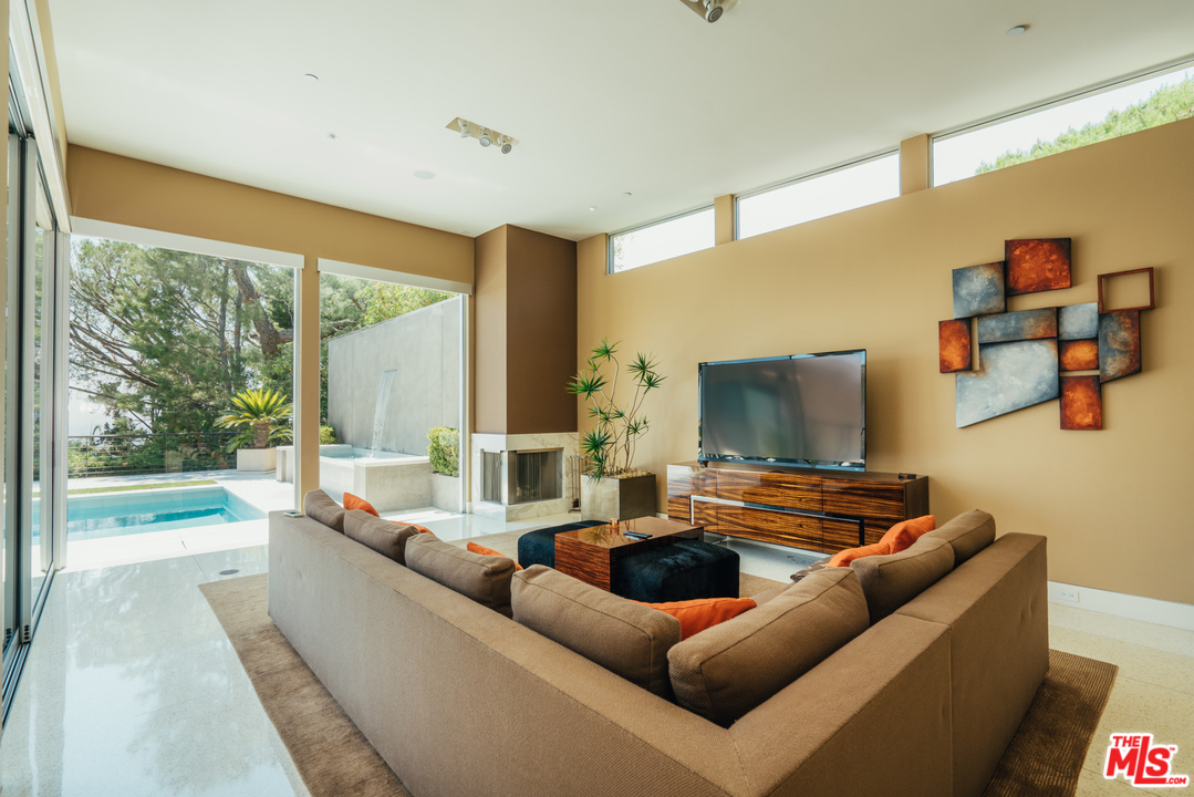 1470 Carla Ridge Beverly Hills, CA 90210 - Photo 28 of 44 a living room with furniture and a flat screen tv