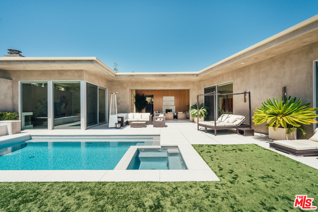 1470 Carla Ridge Beverly Hills, CA 90210 - Photo 34 of 44 a view of a swimming pool with furniture