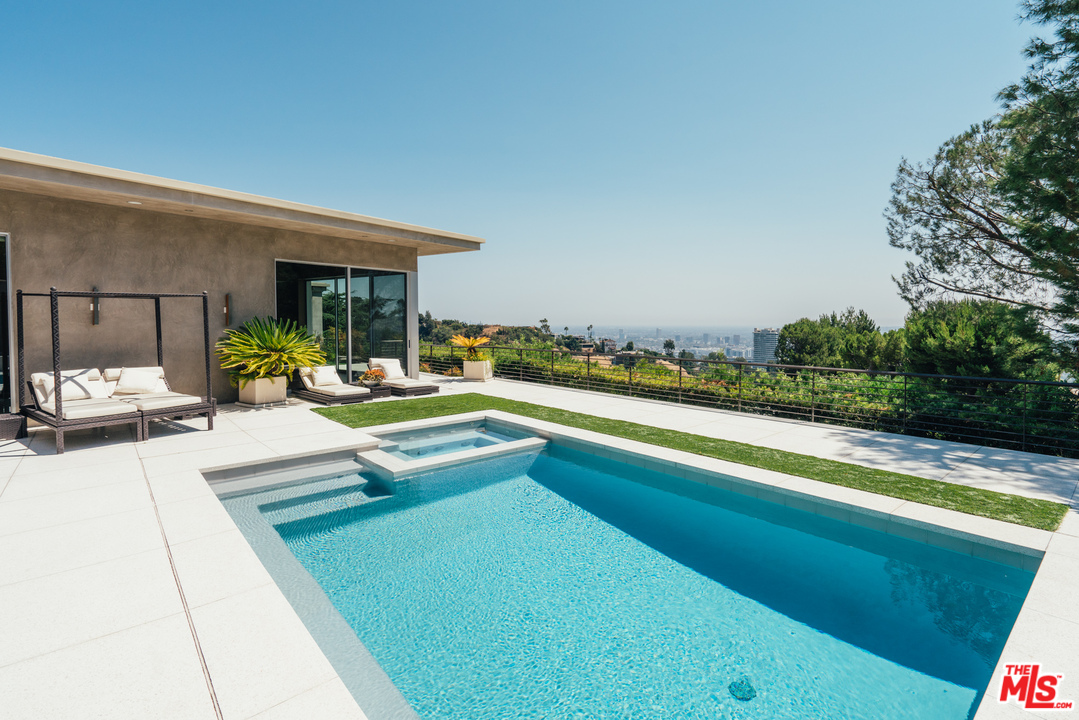 1470 Carla Ridge Beverly Hills, CA 90210 - Photo 38 of 44 a swimming pool with outdoor seating and yard