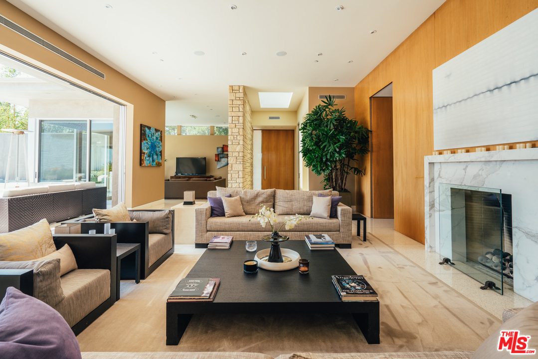 1470 Carla Ridge Beverly Hills, CA 90210 - Photo 5 of 44 a living room with furniture large window and a fireplace