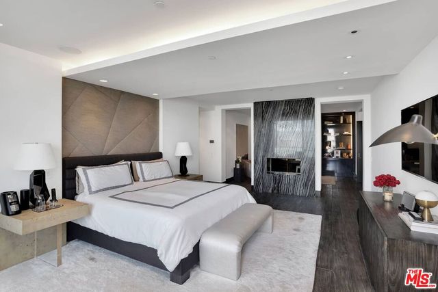 a bedroom with a bed and a large mirror