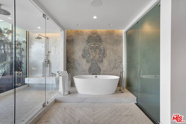 a spacious bathroom with a bathtub and shower