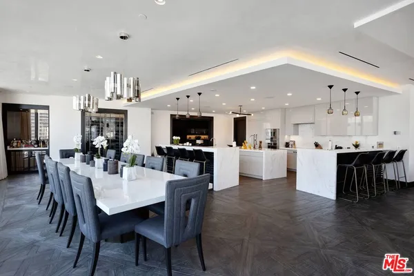 a large kitchen with a table and chairs