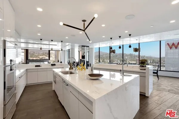 a large white kitchen with a large window