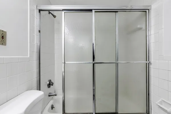 a bathroom with a glass shower door