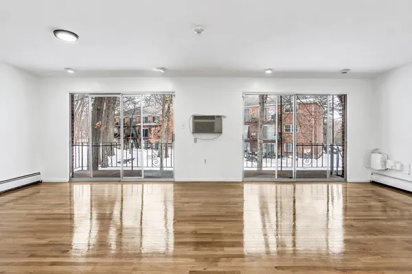 a view of wooden floor and windows in a room