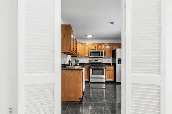 a kitchen with stainless steel appliances a refrigerator and a stove top oven