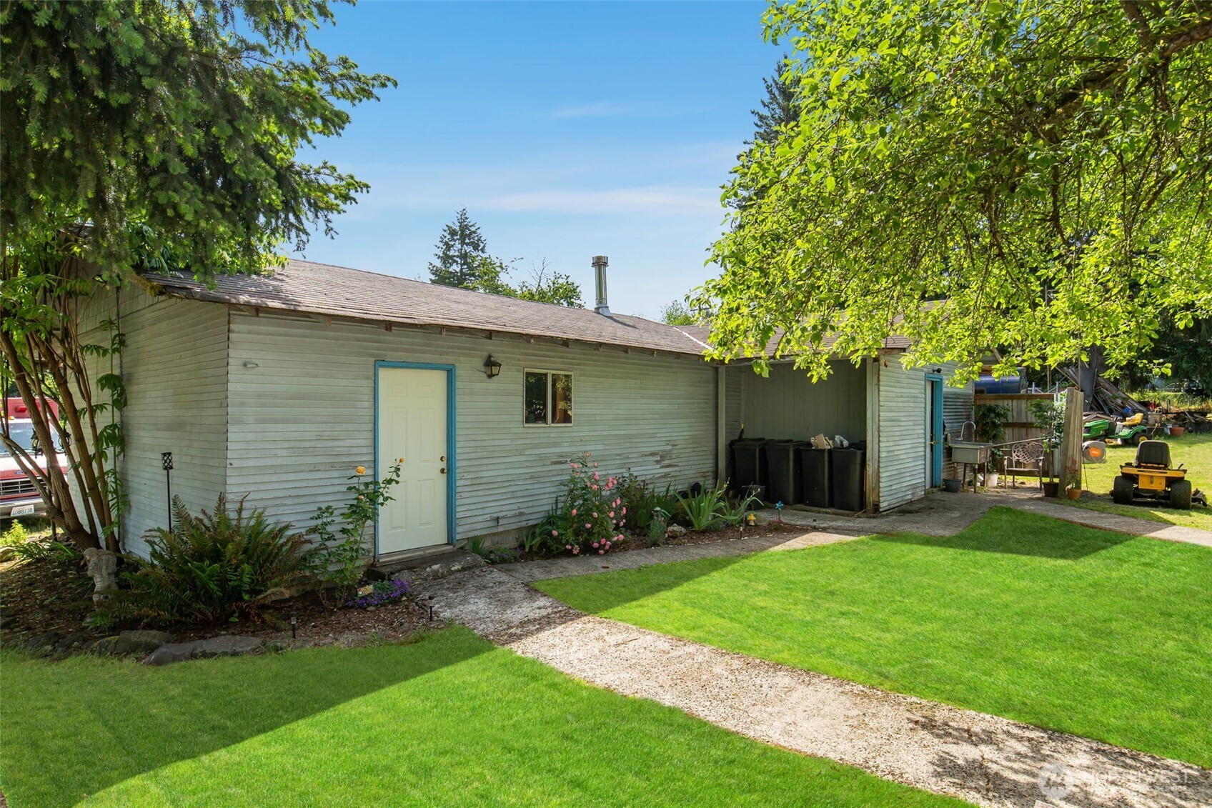 1497 Old Military Road Southeast Tenino, WA 98589 - Photo 29 of 34 a view of a backyard with table and chairs and a large tree