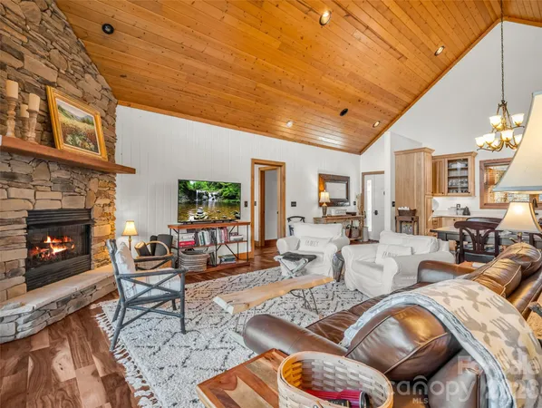a living room with furniture a fireplace and a table