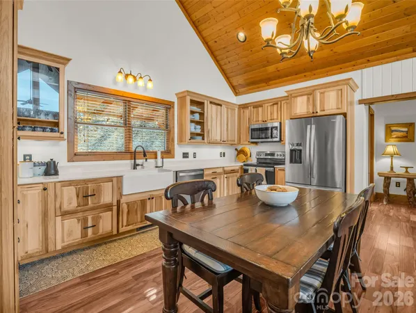 a kitchen with a table chairs stove and refrigerator