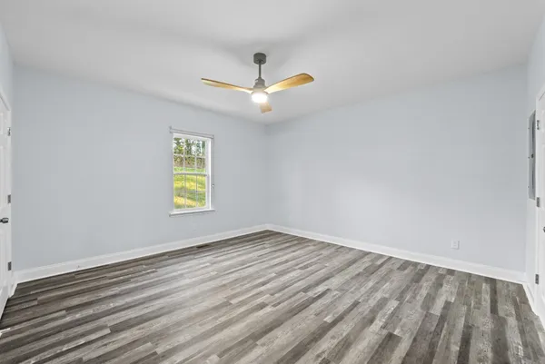 wooden floor in an empty room with a window