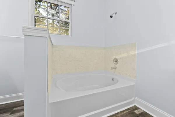 a white bath tub sitting next to a window