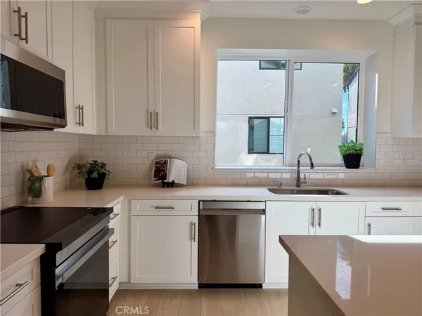 a kitchen with a sink stove and microwave