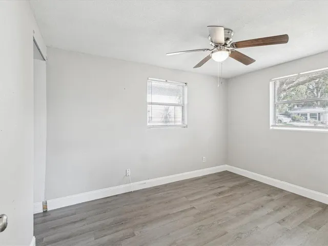 wooden floor in an empty room with a window