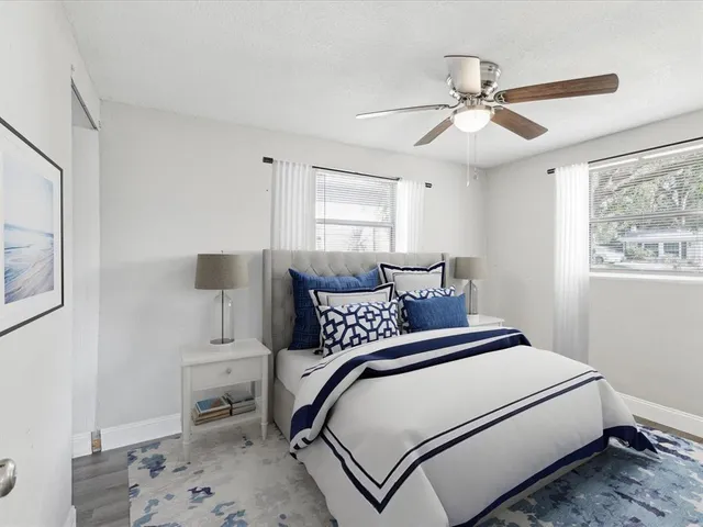 a bedroom with a bed and a window