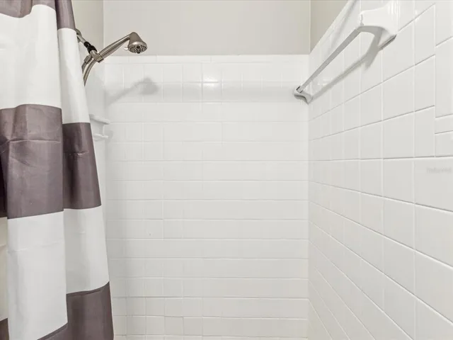 a bathroom with a shower and a shower