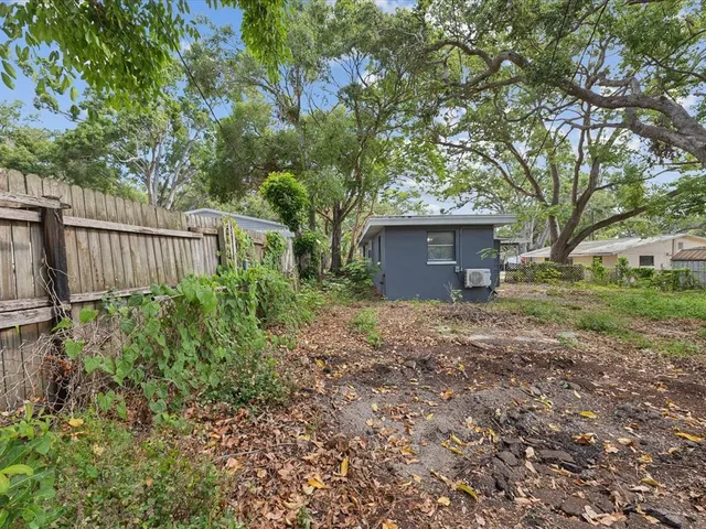 a view of a house with a yard and tree s