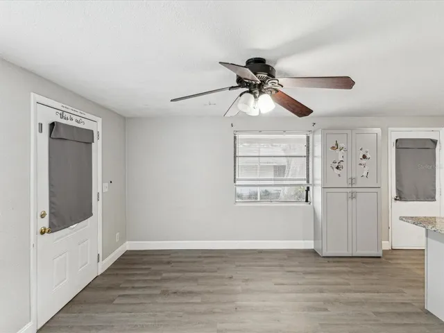 a view of a big room with wooden floor and cabinet