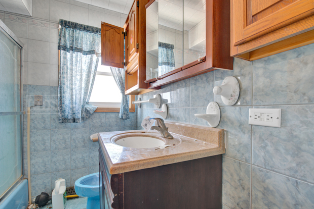 1067 West 97th Street Chicago, IL 60643 - Photo 12 of 15 a bathroom with a sink and a mirror