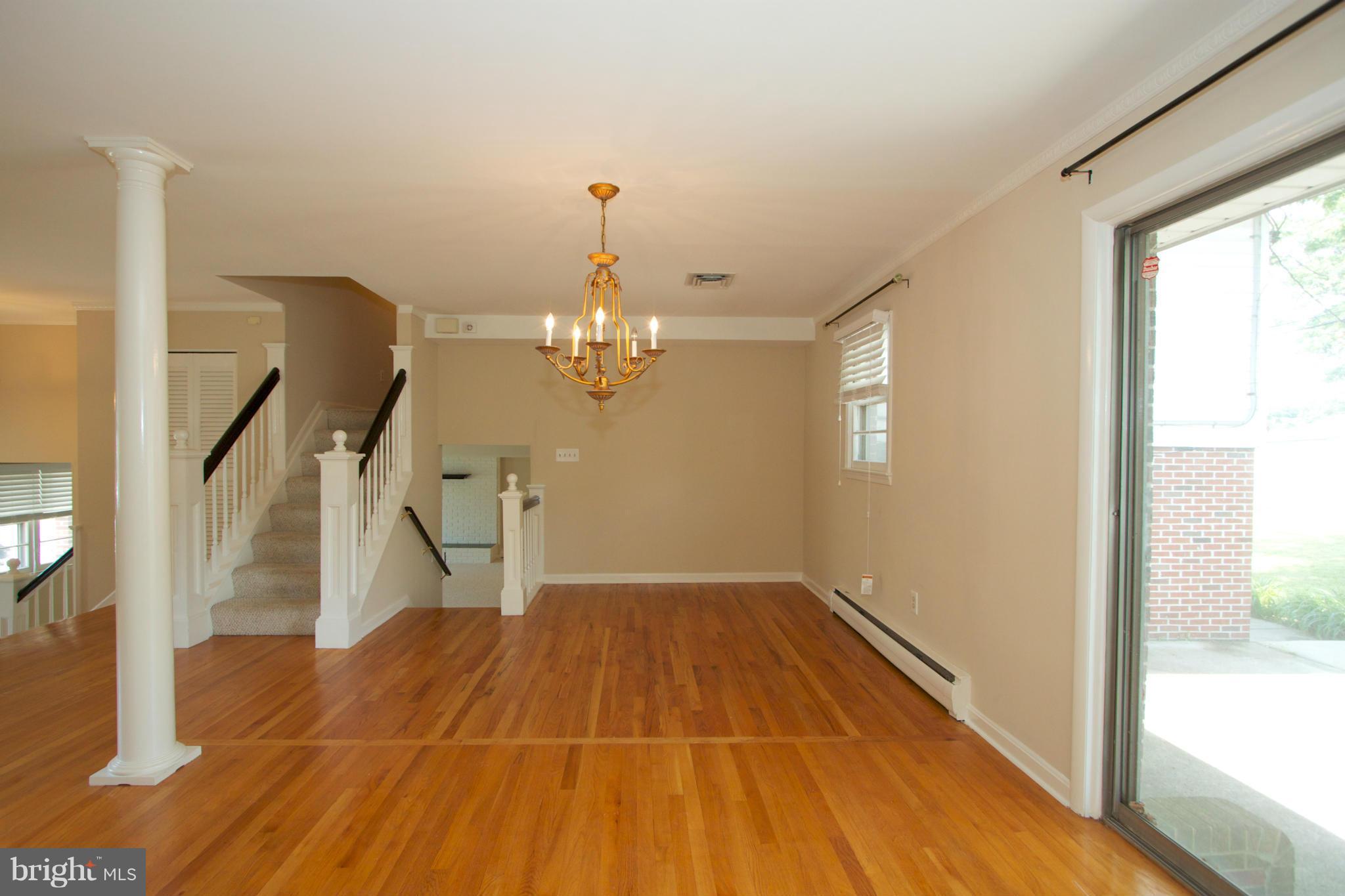 8438 Coco Road Baltimore, MD 21237 - Photo 11 of 29 a view of an empty room with wooden floor and a window