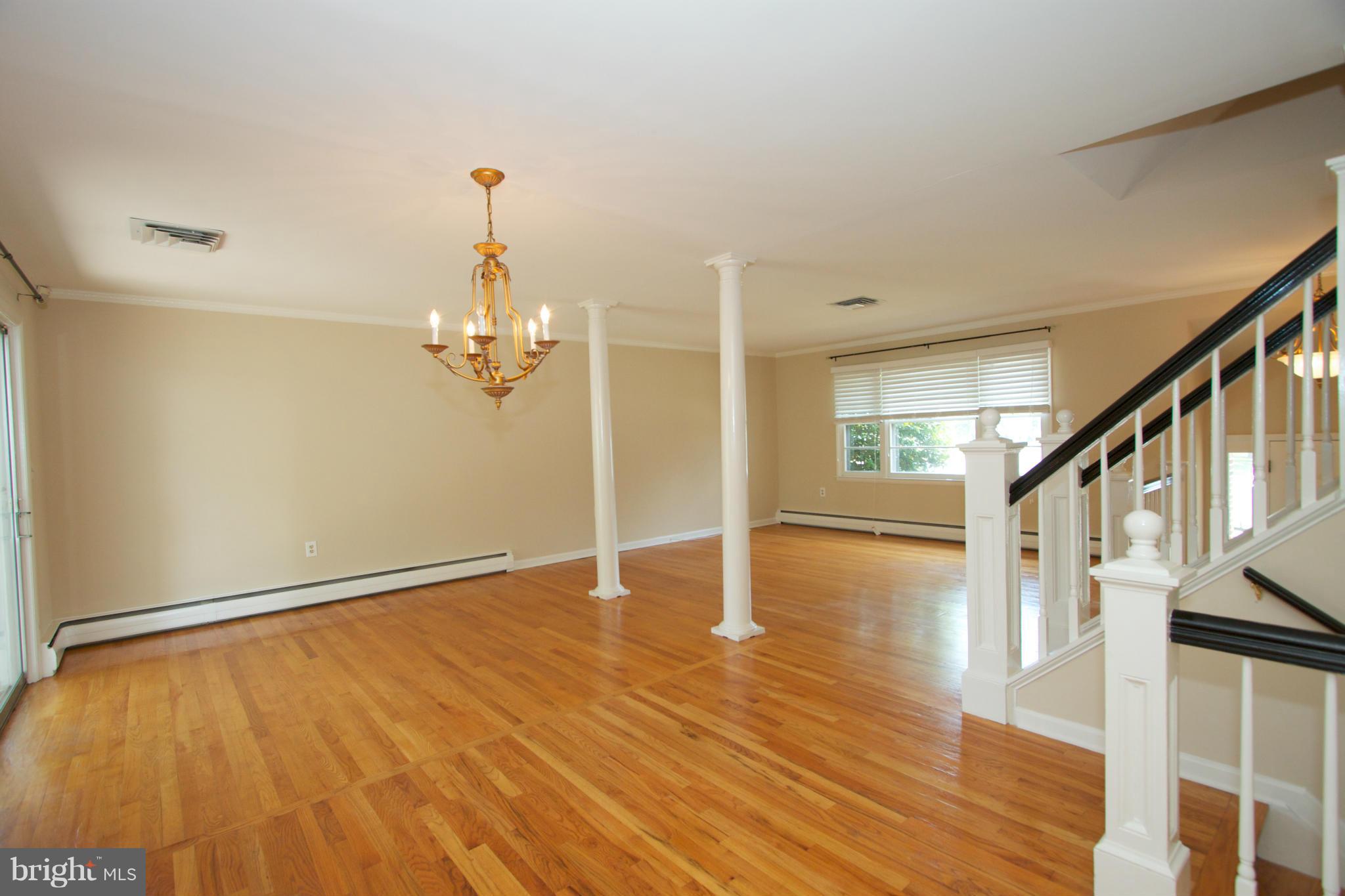8438 Coco Road Baltimore, MD 21237 - Photo 12 of 29 a view of empty room with wooden floor and fan