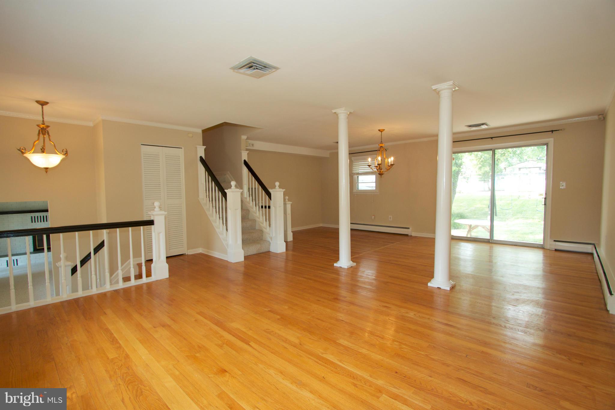 8438 Coco Road Baltimore, MD 21237 - Photo 14 of 29 a view of an empty room with wooden floor and a window