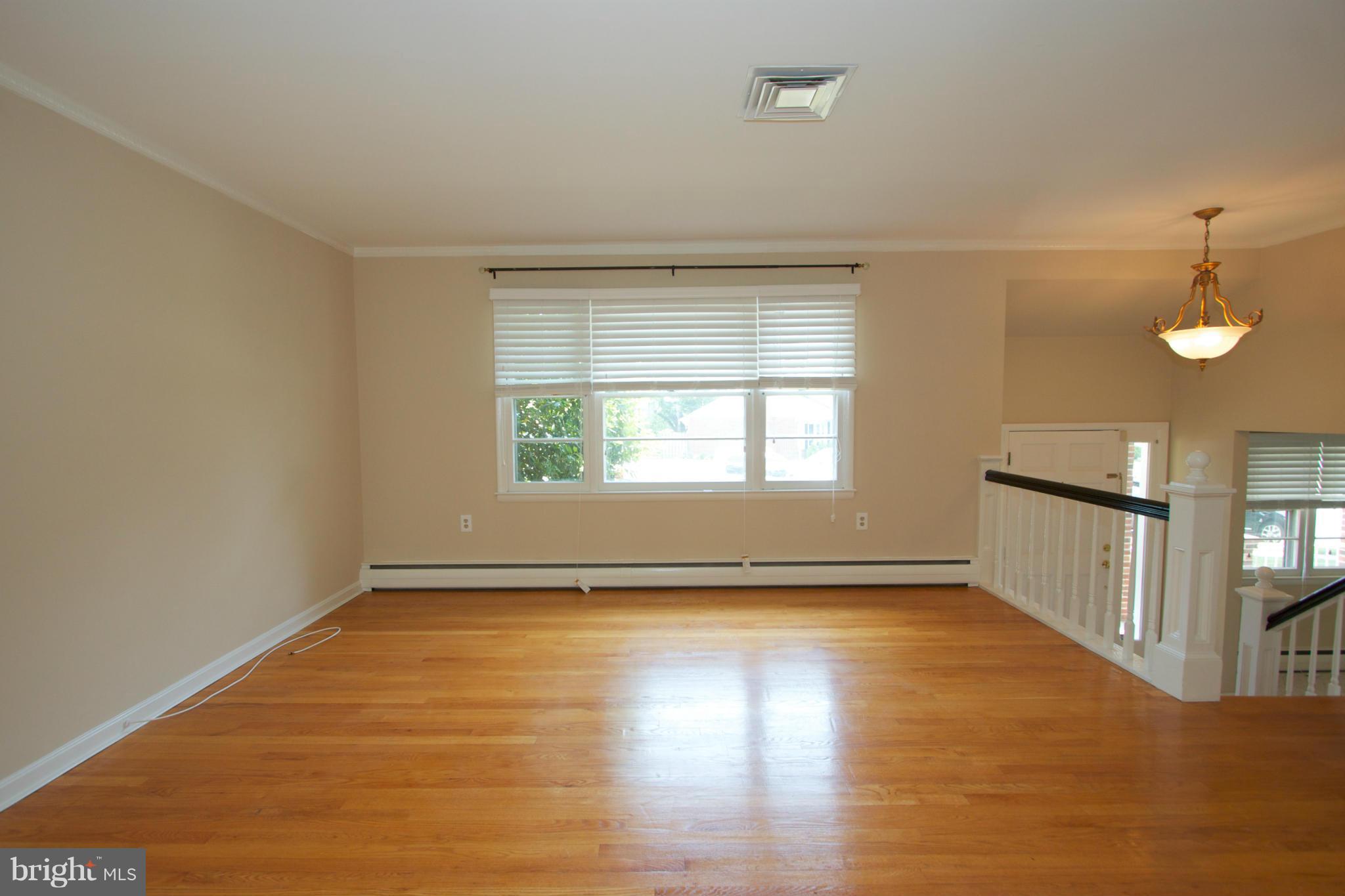 8438 Coco Road Baltimore, MD 21237 - Photo 15 of 29 an empty room with wooden floor and windows