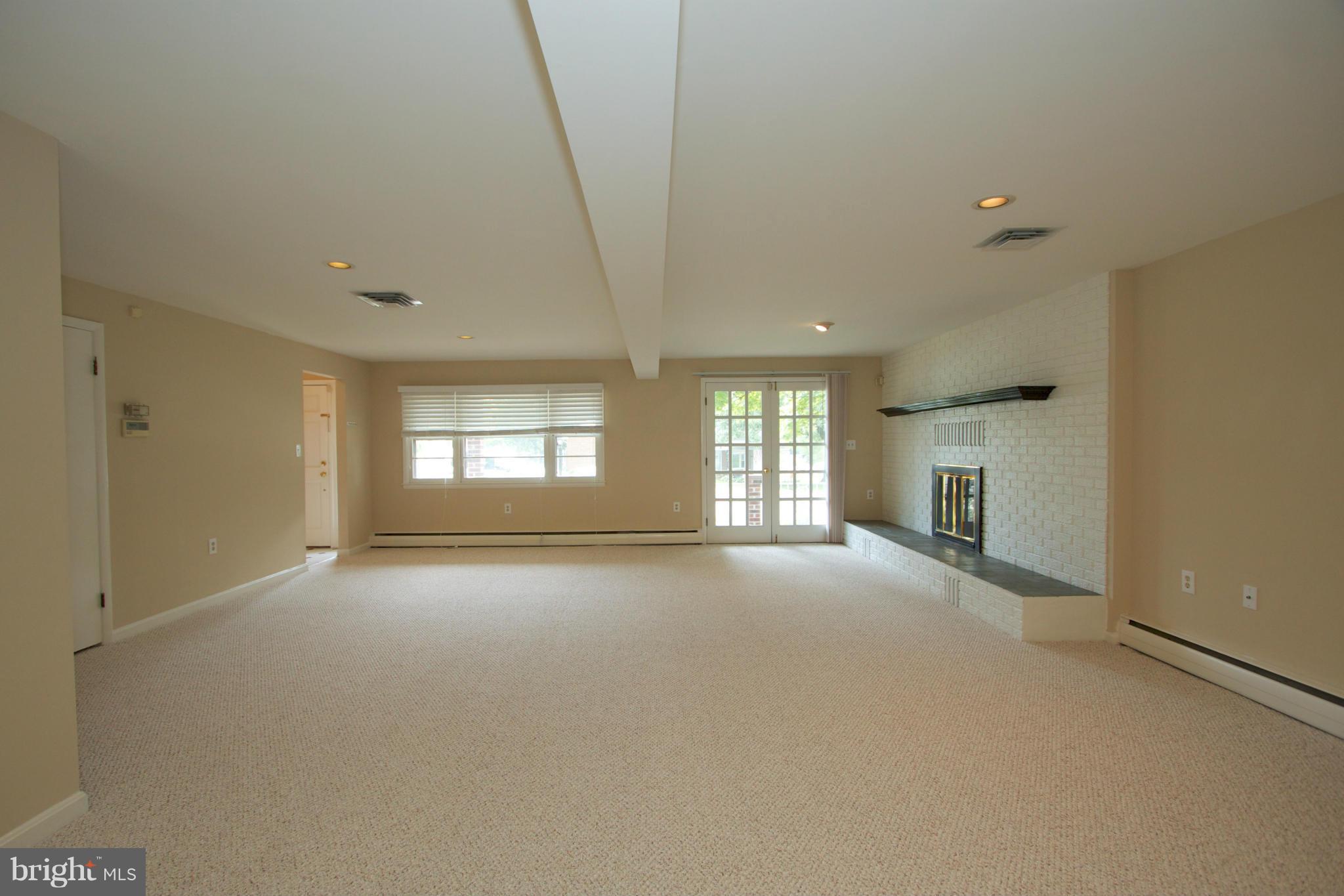 8438 Coco Road Baltimore, MD 21237 - Photo 3 of 29 a view of empty room with a fireplace