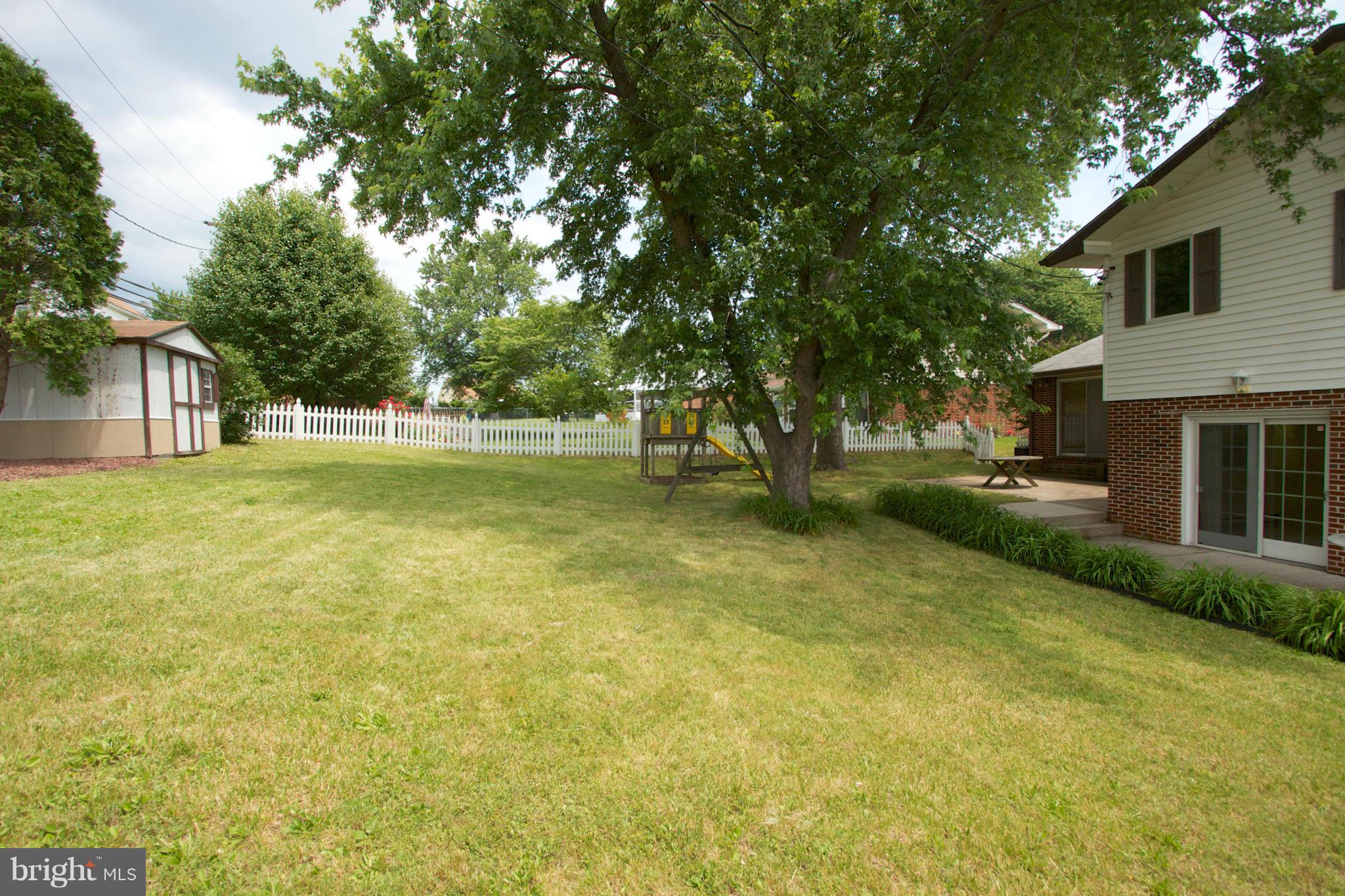 8438 Coco Road Baltimore, MD 21237 - Photo 25 of 29 a backyard of a house with lots of green space and fountain