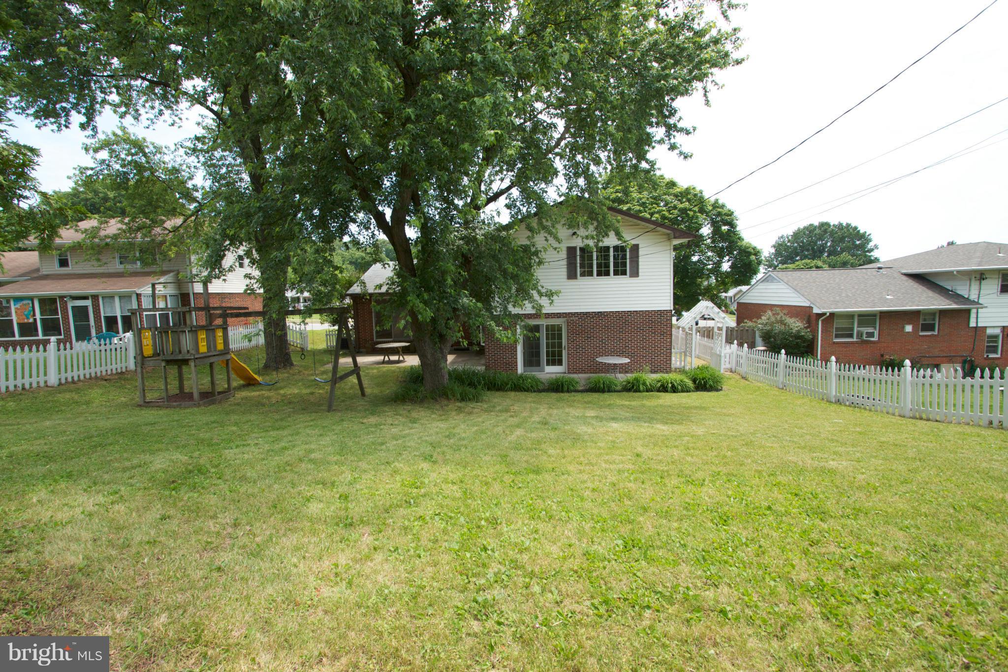 8438 Coco Road Baltimore, MD 21237 - Photo 29 of 29 a front view of a house with a garden and sitting area