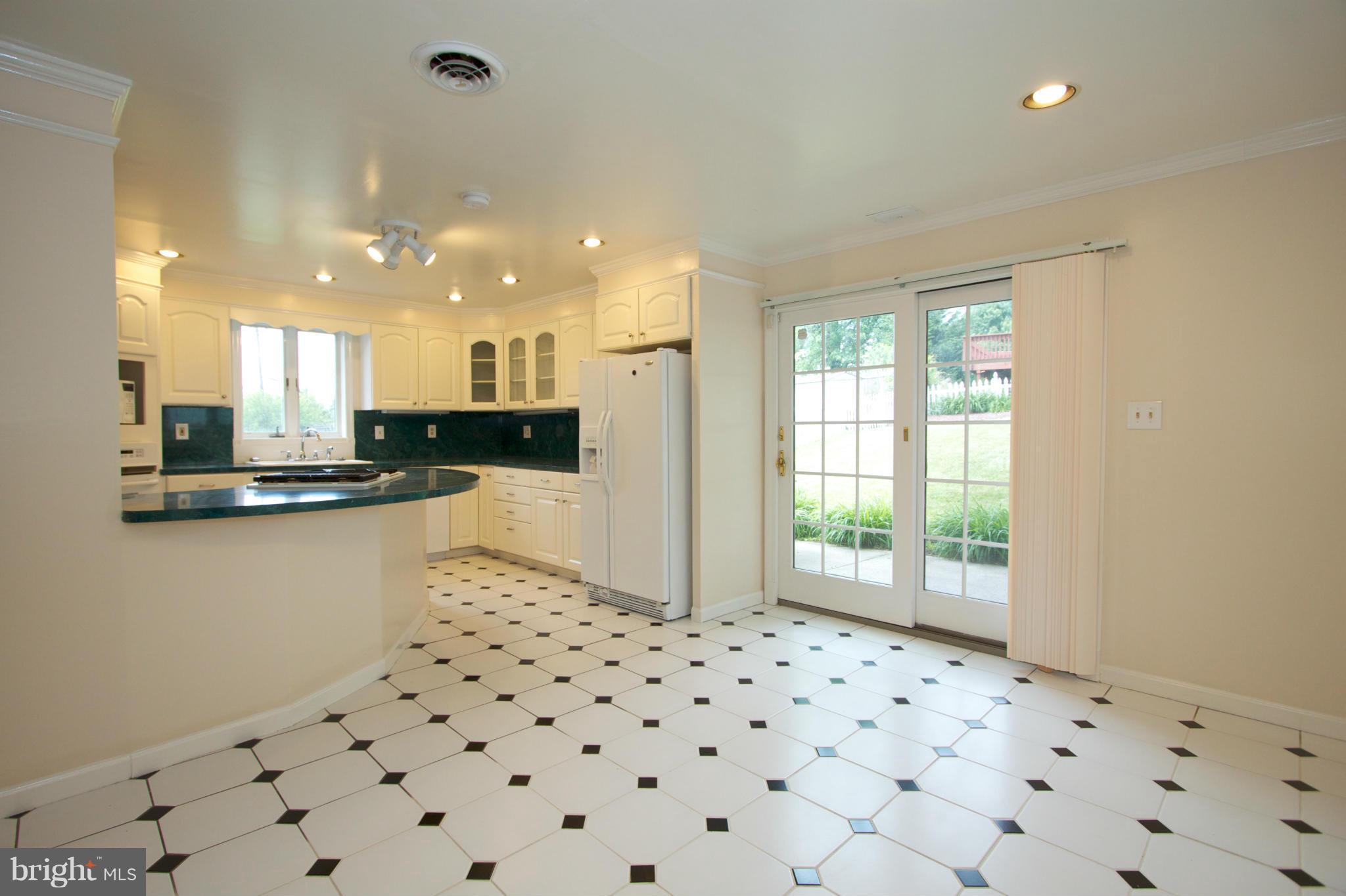 8438 Coco Road Baltimore, MD 21237 - Photo 7 of 29 a kitchen with granite countertop a refrigerator and a sink