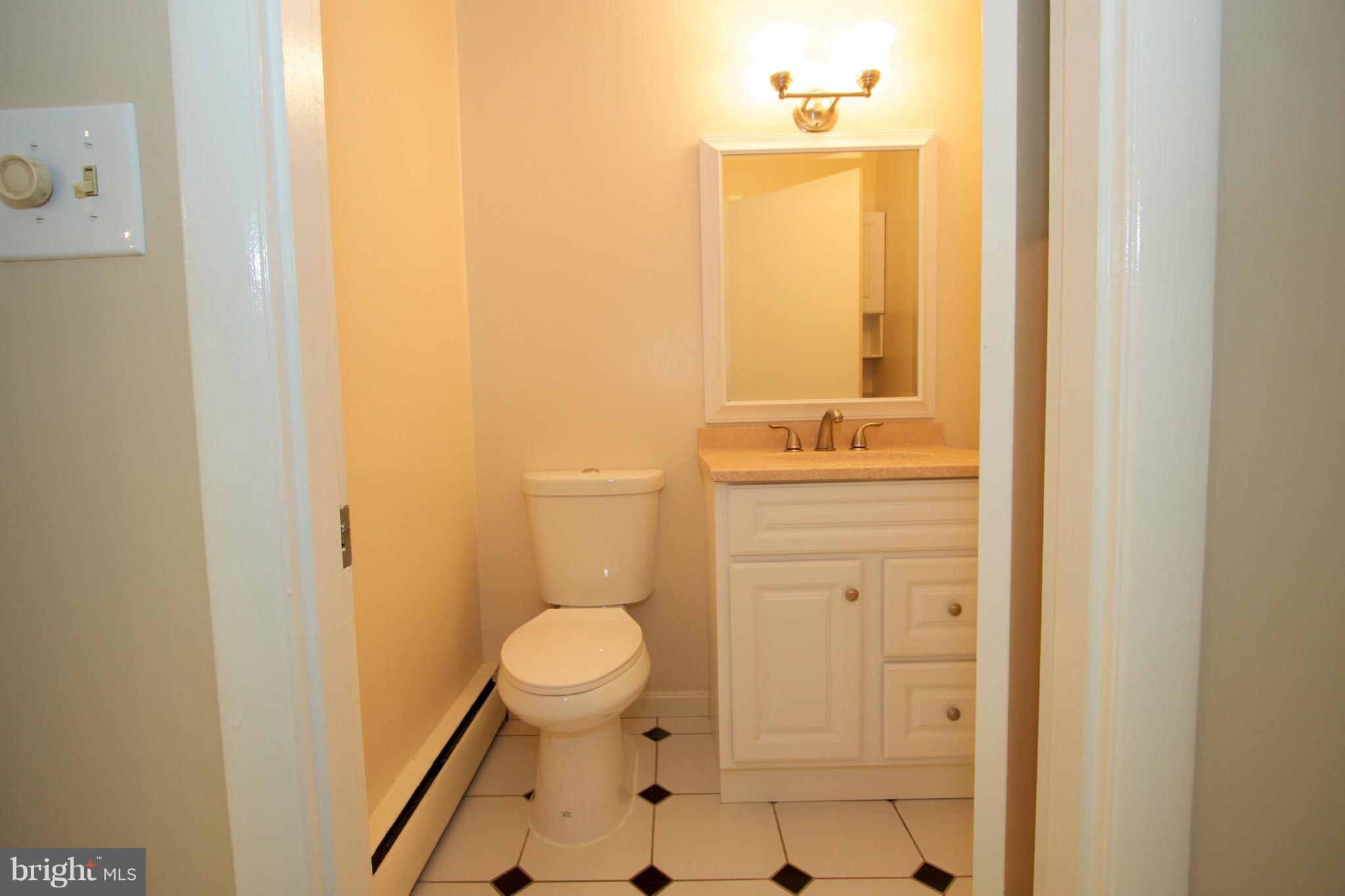 8438 Coco Road Baltimore, MD 21237 - Photo 9 of 29 a bathroom with a sink a toilet and shower