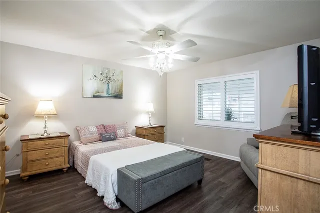 a bedroom with a bed and a flat tv screen on a dresser