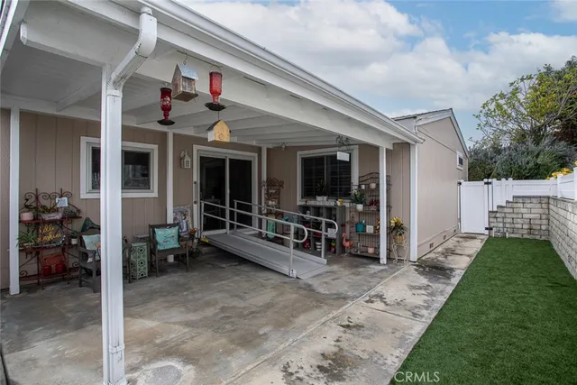 a view of a porch with chairs and a yard