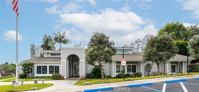 a view of swimming pool with outdoor seating and house in the background