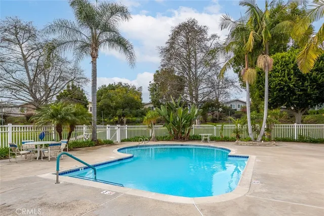 a view of a roof deck with chair and wooden fence