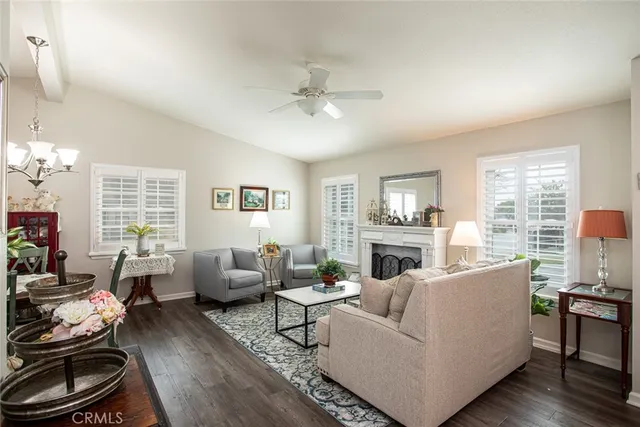 a living room with furniture fireplace and a large window
