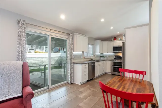 a kitchen with sink refrigerator and stove