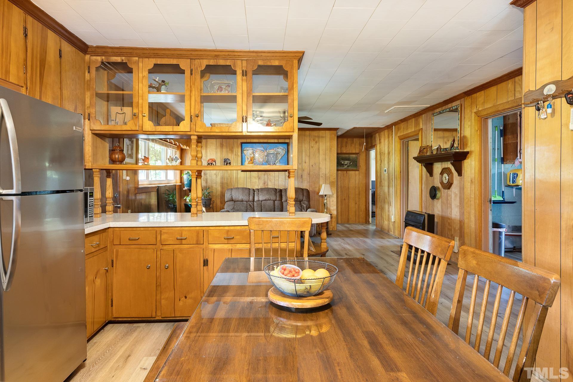724 Bill Poole Road Rougemont, NC 27572 - Photo 8 of 17 a kitchen with a refrigerator and wooden floor